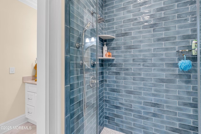 bathroom with vanity and a tile shower