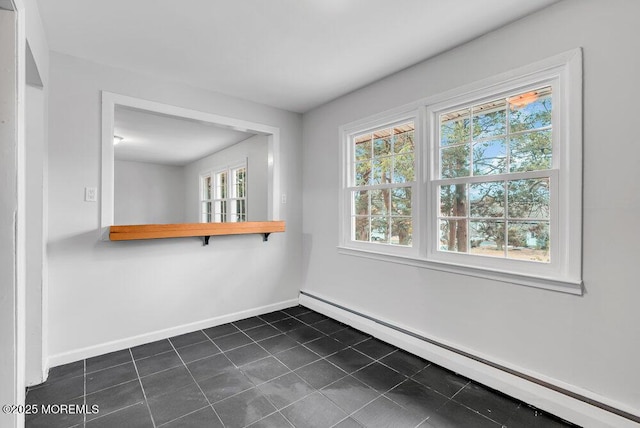 tiled empty room with a baseboard radiator