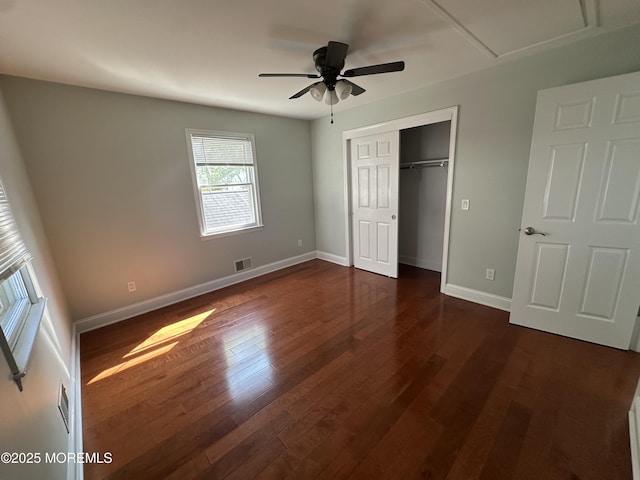 unfurnished bedroom featuring dark hardwood / wood-style floors, ceiling fan, and a closet