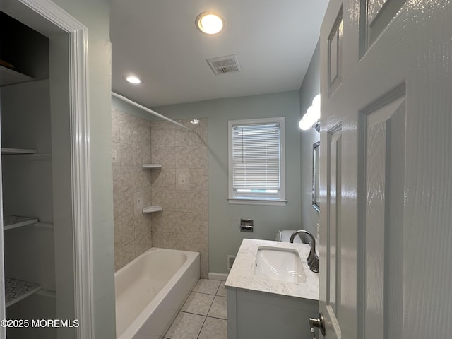 bathroom featuring vanity, tile patterned floors, and tiled shower / bath