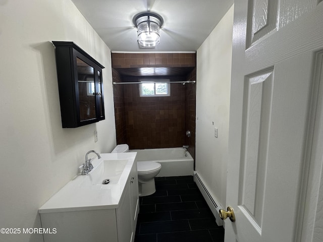 full bathroom with tiled shower / bath, vanity, baseboard heating, toilet, and tile patterned floors