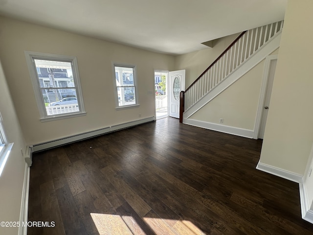 foyer entrance with a baseboard heating unit and dark hardwood / wood-style floors