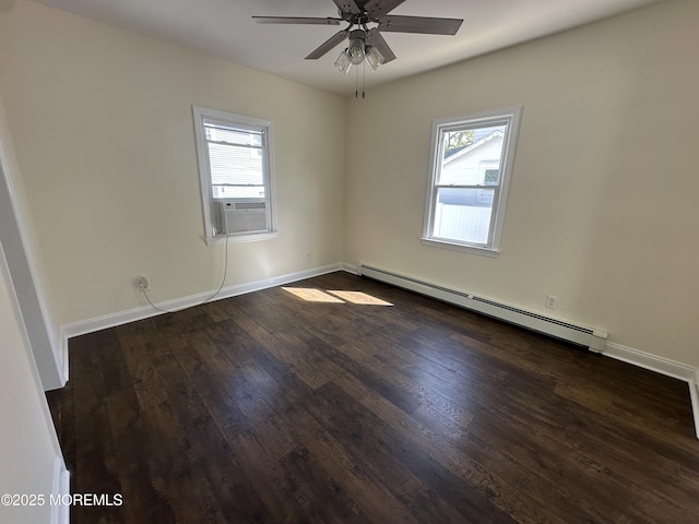 empty room with plenty of natural light, a baseboard heating unit, and dark hardwood / wood-style flooring