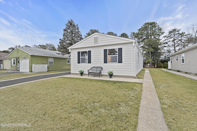 bungalow-style home featuring a patio and a front lawn