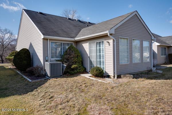 exterior space with a yard and central air condition unit