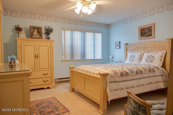 carpeted bedroom featuring ceiling fan and a baseboard heating unit