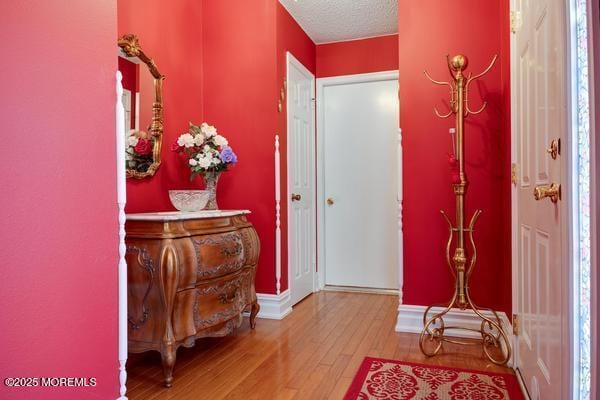 entryway featuring hardwood / wood-style floors and a textured ceiling