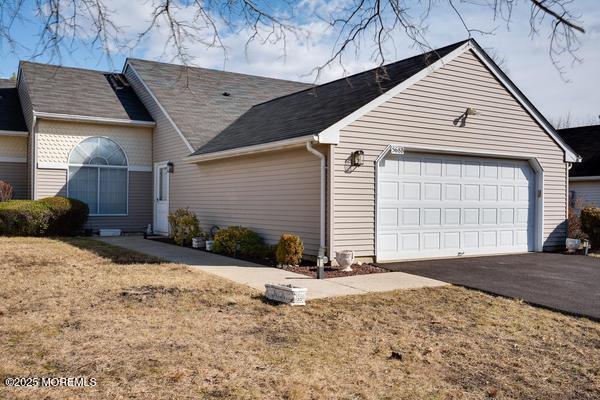 view of front of property with a garage and a front lawn