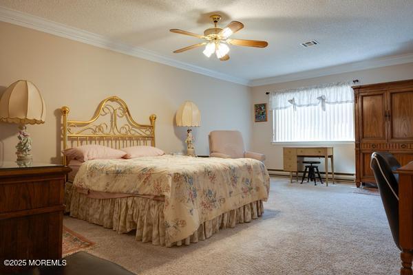 carpeted bedroom with a baseboard heating unit, crown molding, a textured ceiling, and ceiling fan