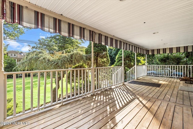 wooden terrace with a yard