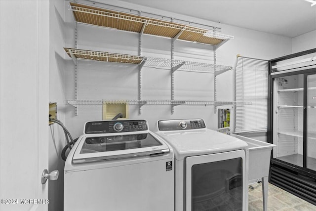 clothes washing area featuring washer and dryer