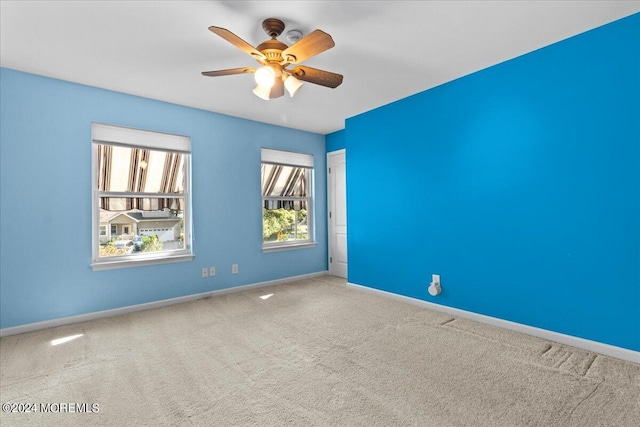 empty room featuring carpet floors and ceiling fan