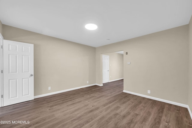 empty room featuring dark wood-type flooring