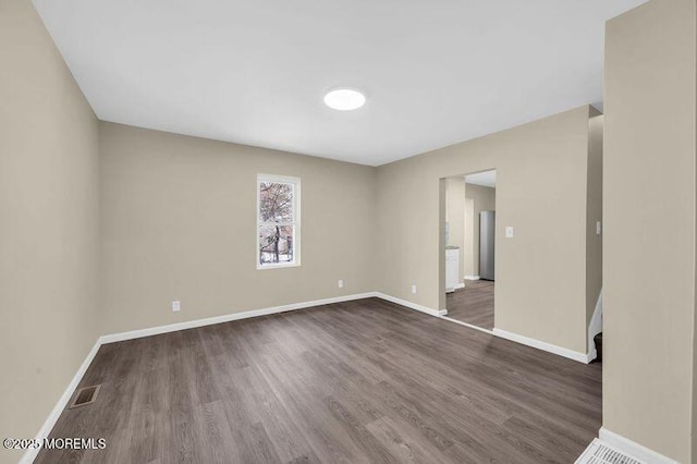 spare room with dark hardwood / wood-style floors