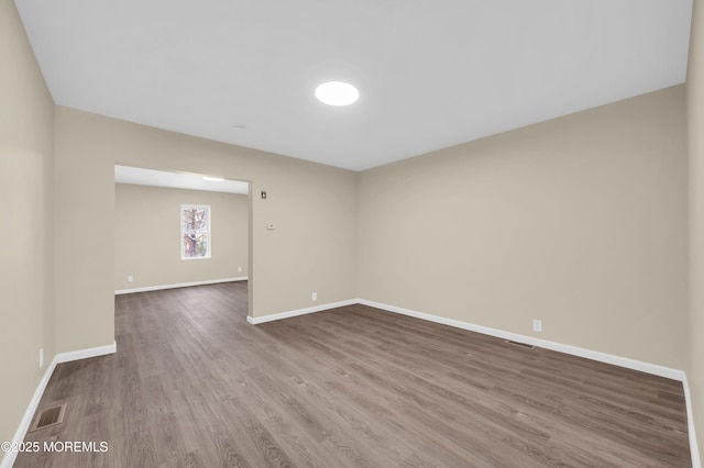 unfurnished room featuring hardwood / wood-style flooring