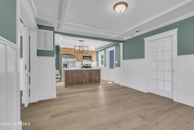 unfurnished living room with coffered ceiling, light hardwood / wood-style flooring, a chandelier, and beamed ceiling