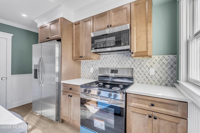 kitchen featuring decorative backsplash, ornamental molding, and stainless steel appliances