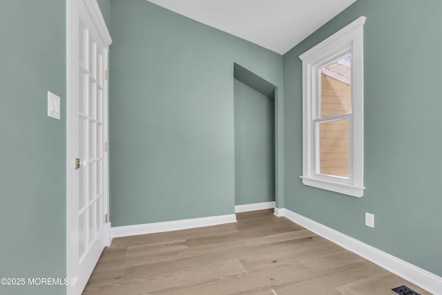 spare room featuring plenty of natural light and light wood-type flooring