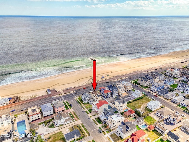 drone / aerial view with a water view and a view of the beach