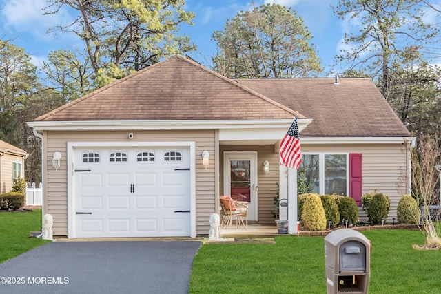 view of front of home with a garage and a front lawn