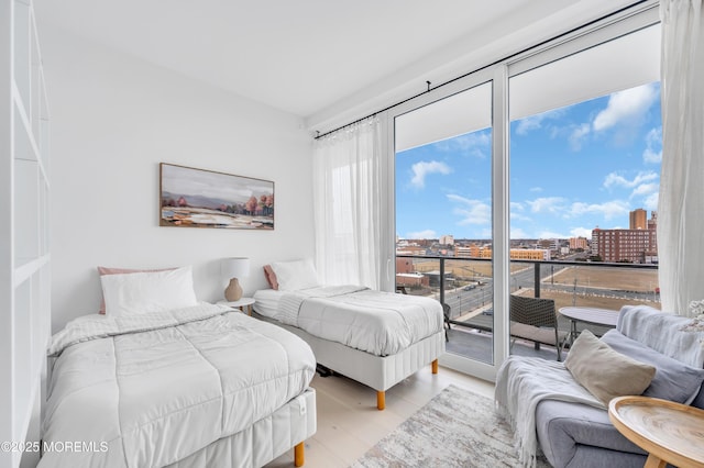 bedroom featuring light hardwood / wood-style flooring and access to exterior