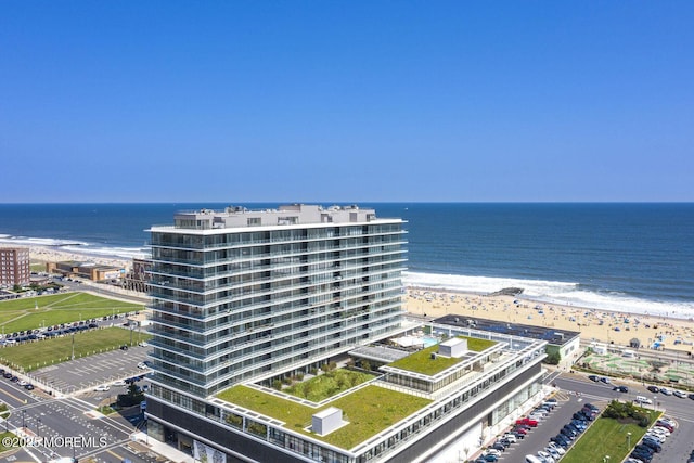 bird's eye view with a water view and a view of the beach