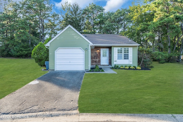 ranch-style home with a garage and a front yard