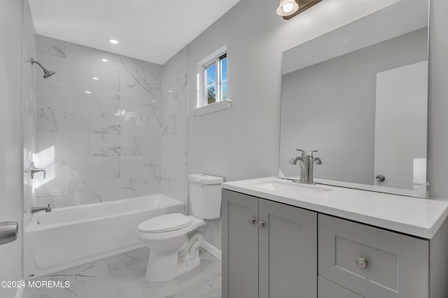 full bathroom featuring tiled shower / bath combo, vanity, and toilet