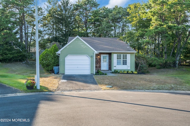 view of front of home featuring a garage and a front lawn