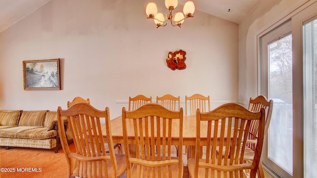 dining room with vaulted ceiling and an inviting chandelier