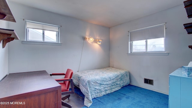 carpeted bedroom featuring visible vents