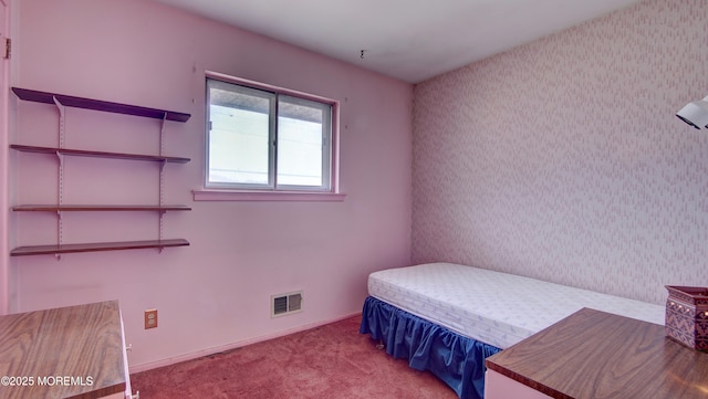 bedroom with visible vents and carpet flooring