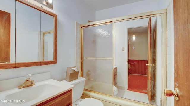 full bathroom featuring toilet, enclosed tub / shower combo, and vanity