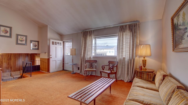 sitting room with carpet floors and vaulted ceiling