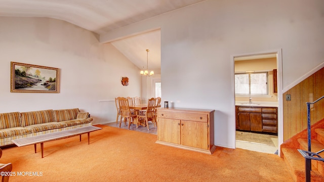 living room with light carpet, high vaulted ceiling, beamed ceiling, and a notable chandelier