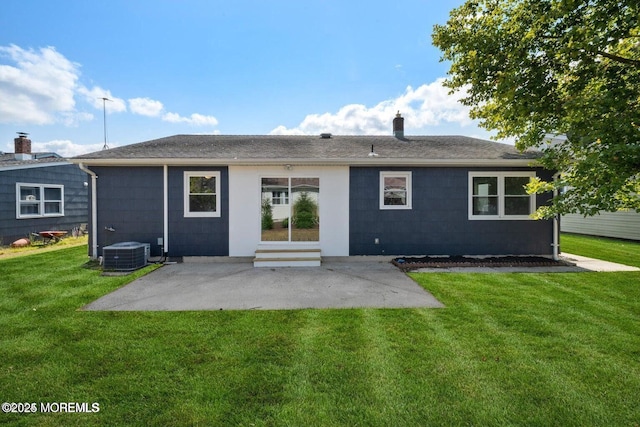 back of property with central AC, a yard, and a patio area