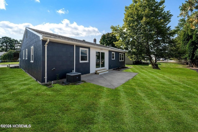 rear view of house featuring a patio, a yard, and cooling unit