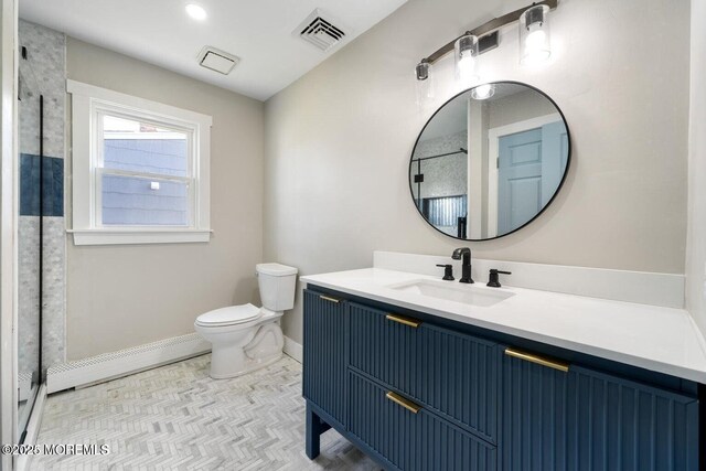 bathroom featuring a baseboard radiator, vanity, and toilet