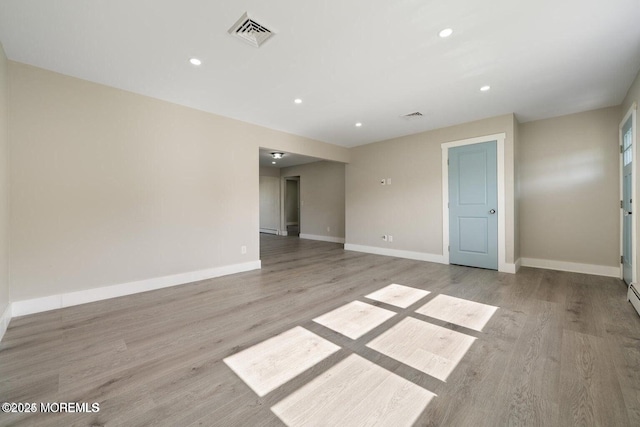 spare room featuring light hardwood / wood-style floors