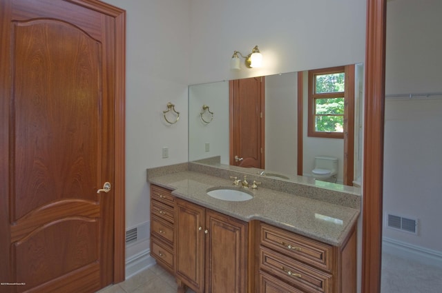 bathroom with vanity, tile patterned floors, and toilet