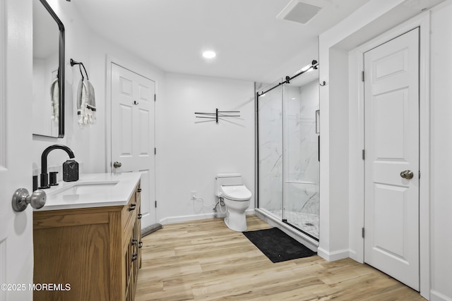 full bathroom with a marble finish shower, vanity, toilet, and wood finished floors