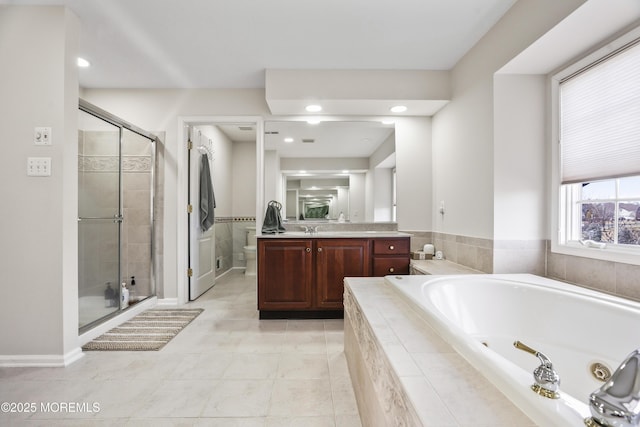 full bathroom featuring toilet, a shower stall, vanity, tile patterned flooring, and a jetted tub