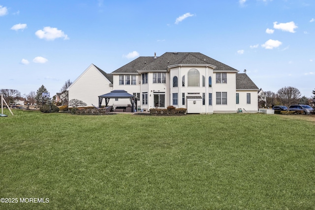 back of house featuring a yard and a gazebo