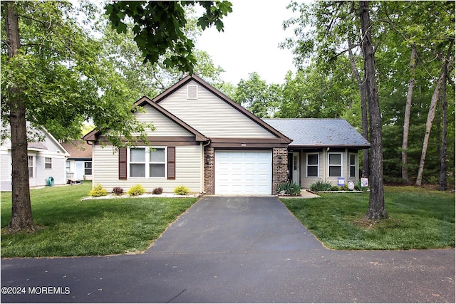 view of front of property with a garage, aphalt driveway, a front lawn, and brick siding