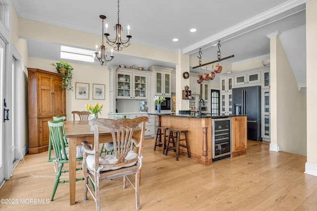 kitchen with light wood finished floors, high quality fridge, wine cooler, and dark countertops