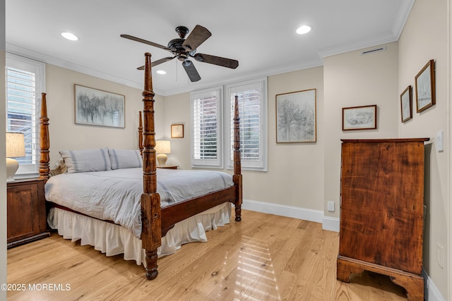 bedroom featuring ornamental molding, visible vents, and multiple windows