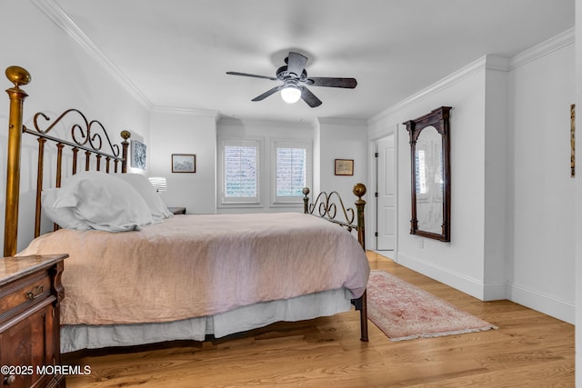 bedroom featuring light wood-type flooring, baseboards, ornamental molding, and ceiling fan