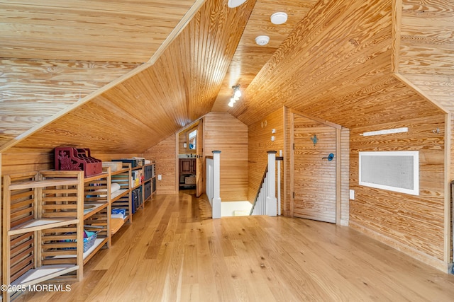 bonus room featuring wood ceiling, vaulted ceiling, wooden walls, and wood finished floors