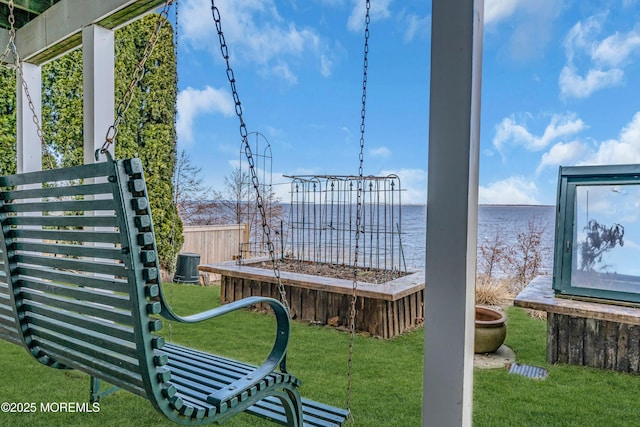 exterior space featuring a water view, fence, and central AC