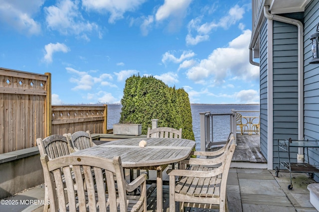 view of patio with outdoor dining space and fence